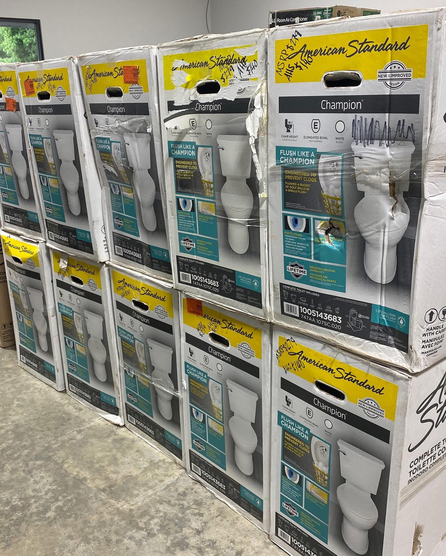 Stacked boxes of American Standard Champion complete elongated toilets