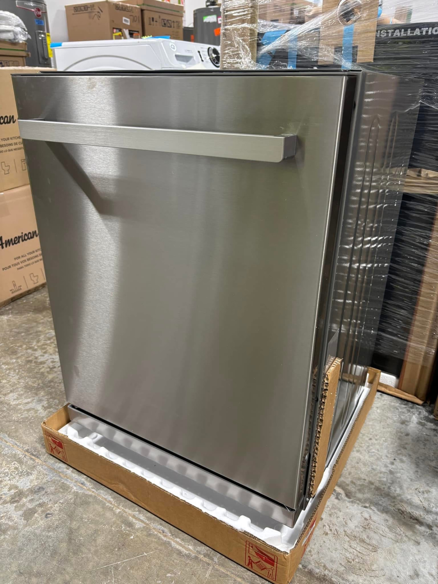 New stainless steel built-in dishwasher sitting on its shipping base at Austin's Home Supply & More