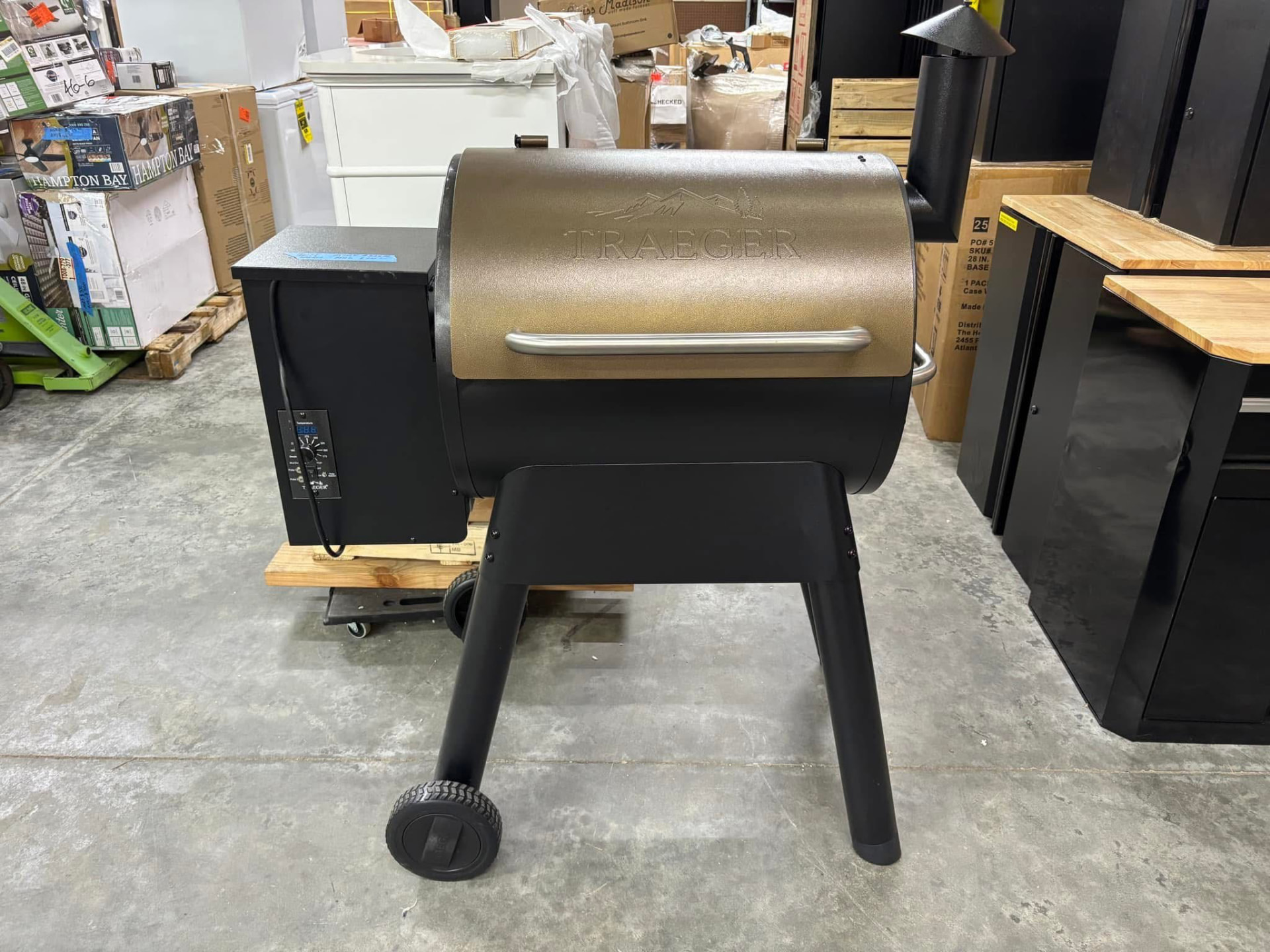 Bronze and black Traeger wood pellet grill and smoker on the floor at Austin's Home Supply & More