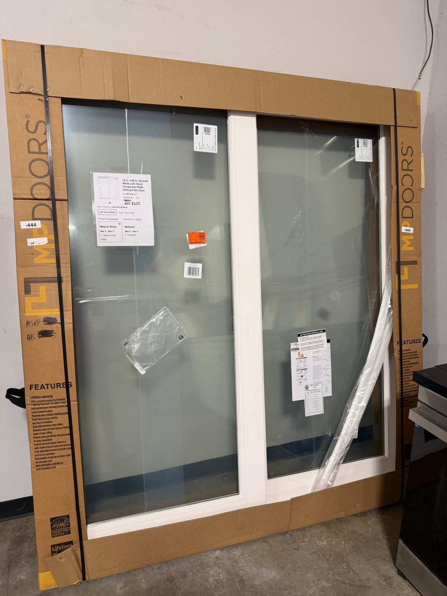 New white composite sliding patio door in its shipping crate at Austin's Home Supply & More